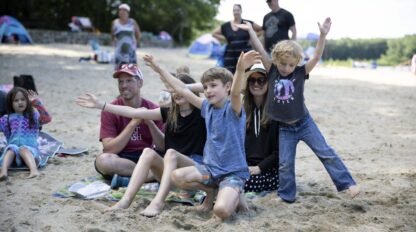 Family and kids in a group pose.