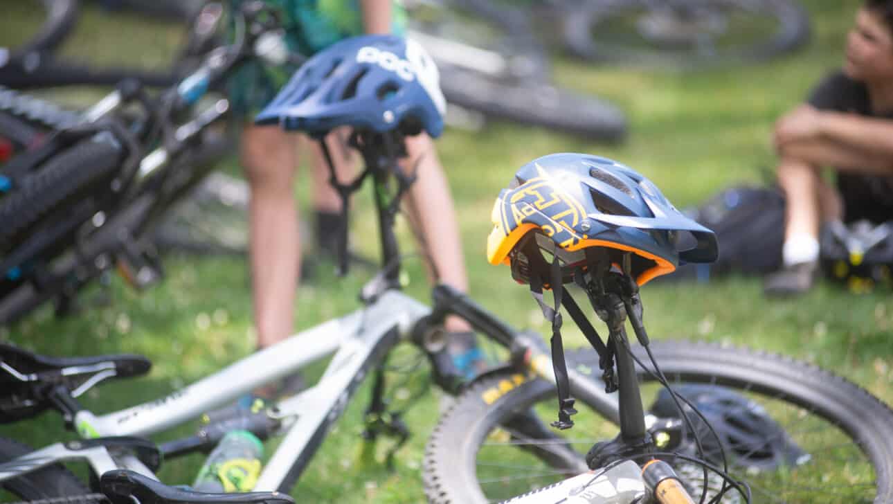 A group of mountain bikes parked on the grass.